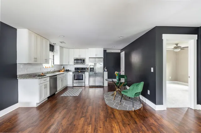 a kitchen with a refrigerator and a white cabinets
