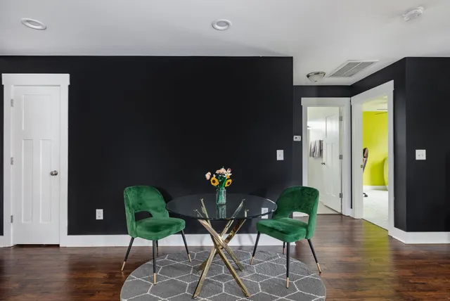 a view of a dining room with furniture and wooden floor