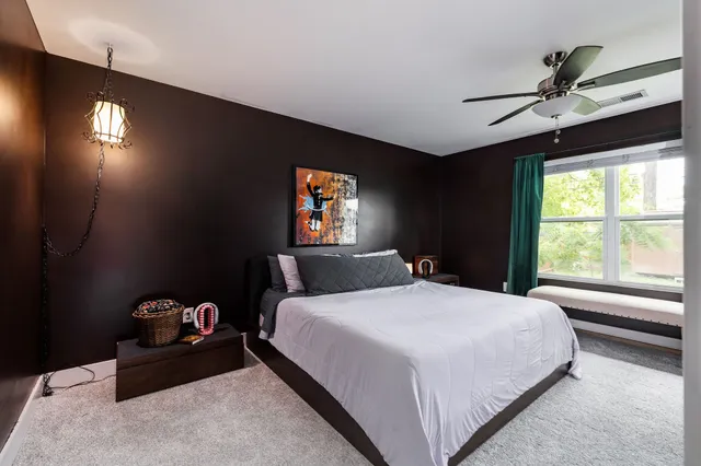 a bedroom with a bed and a chandelier