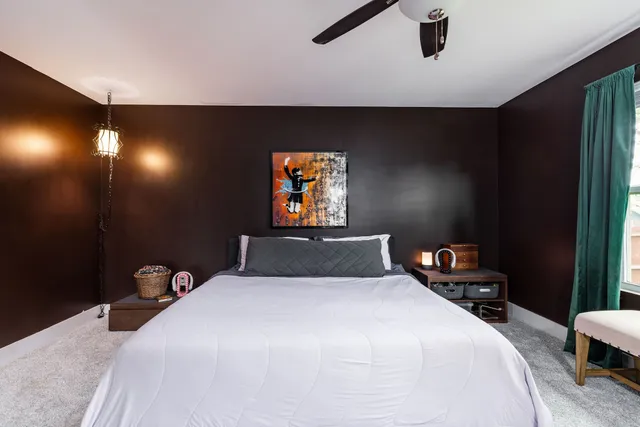 a bedroom with a large bed and a window