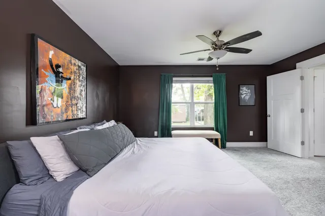 a bedroom with a bed and a chandelier