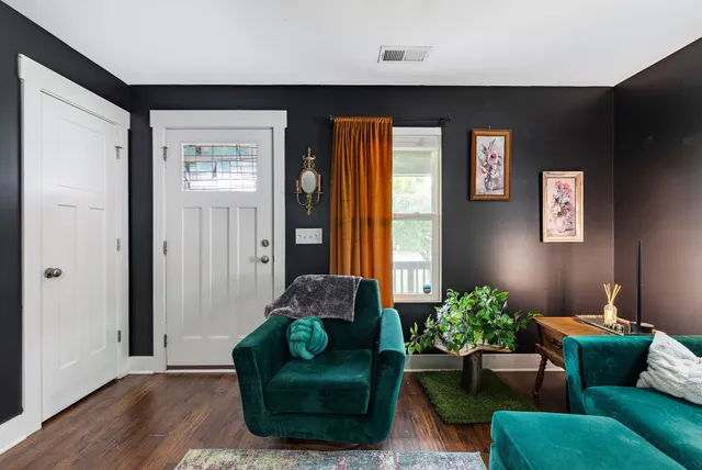 a living room with furniture and a potted plant