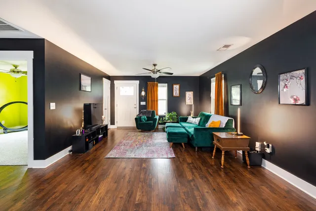 a living room with furniture and wooden floor