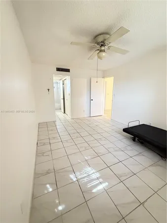 a view of a livingroom with wooden floor and a ceiling fan