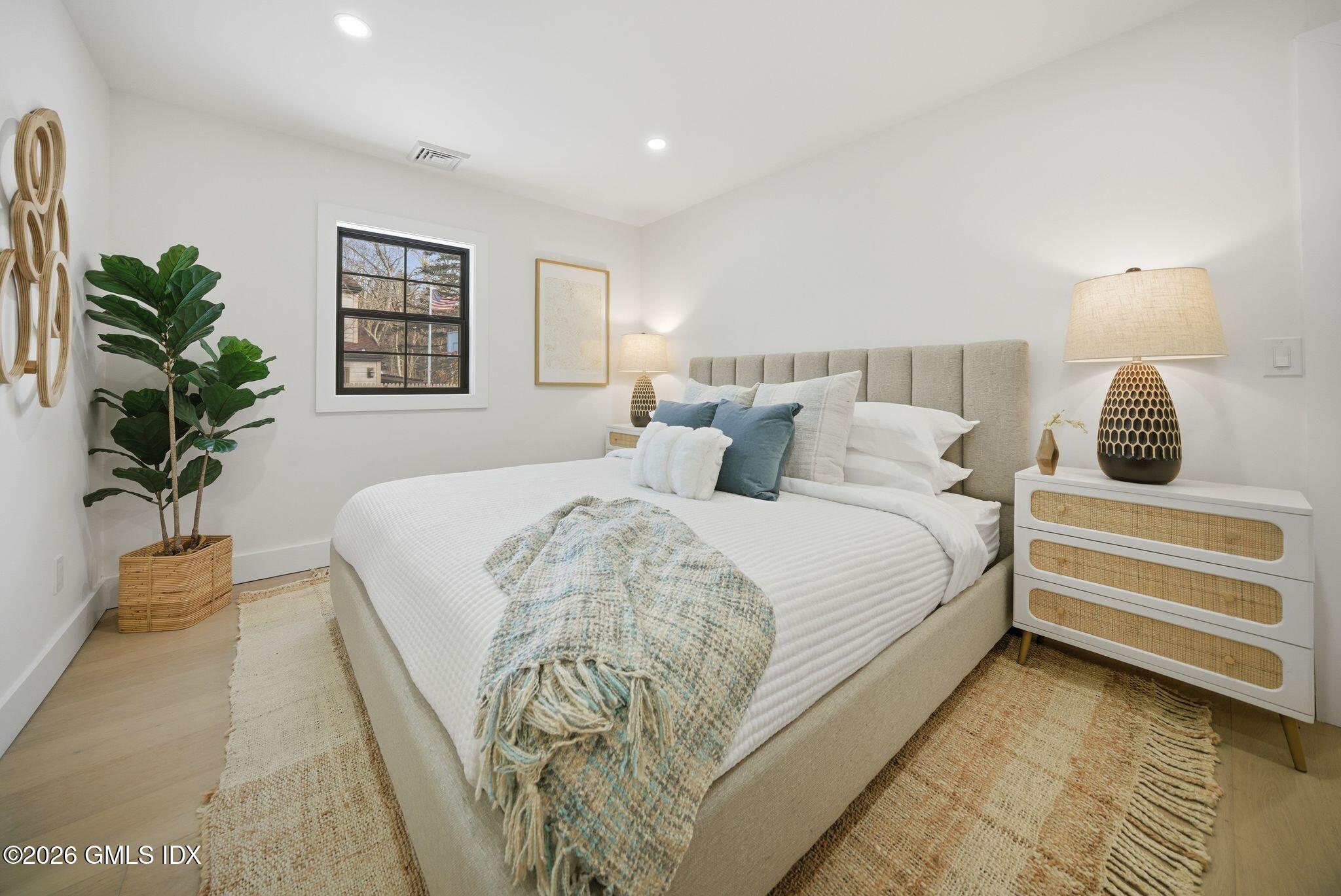101 Parade Hill Road New Canaan, CT 06840 - Photo 22 of 40 a bedroom with a bed and a potted plant