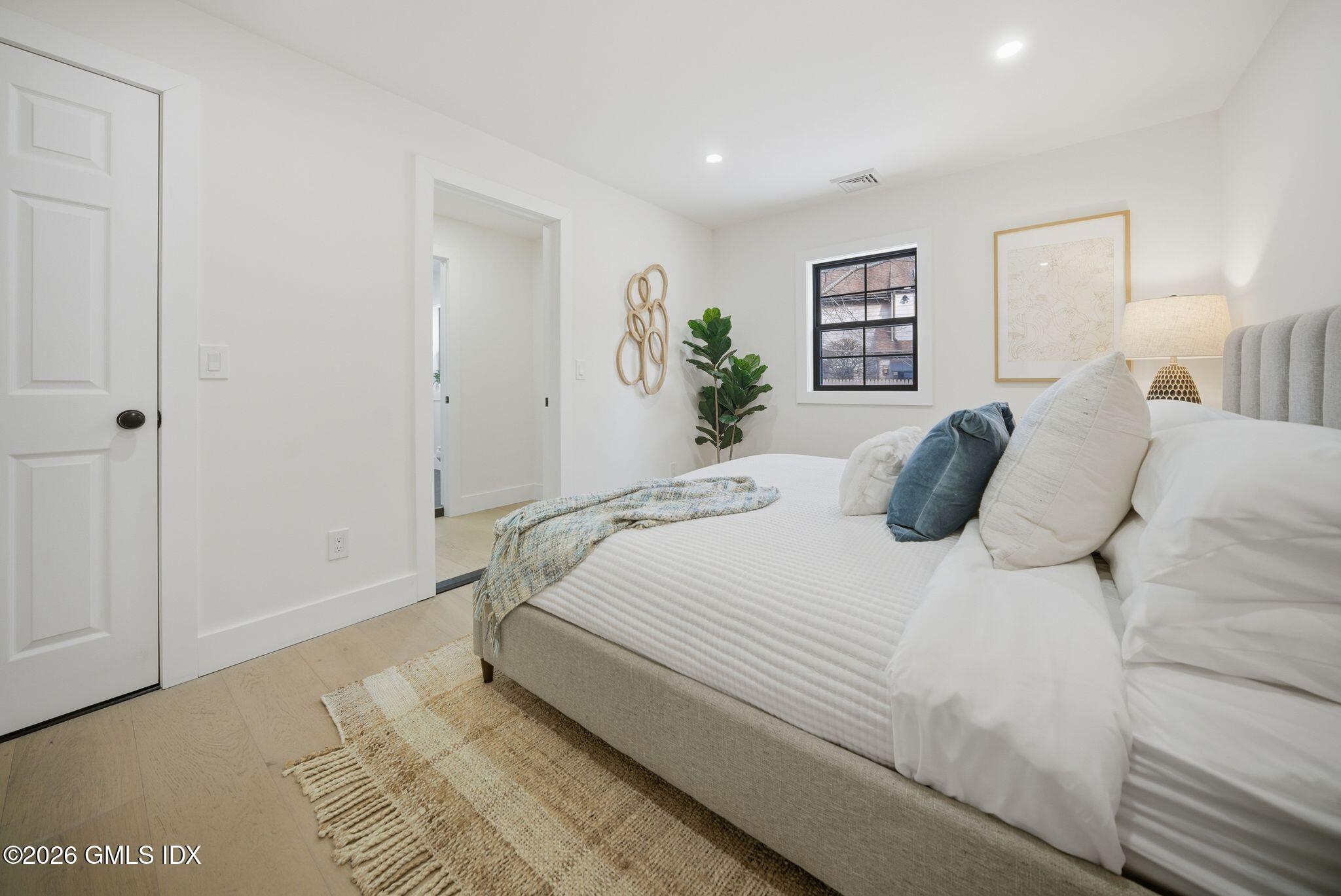 101 Parade Hill Road New Canaan, CT 06840 - Photo 24 of 40 a bedroom with a bed and a painting on the wall