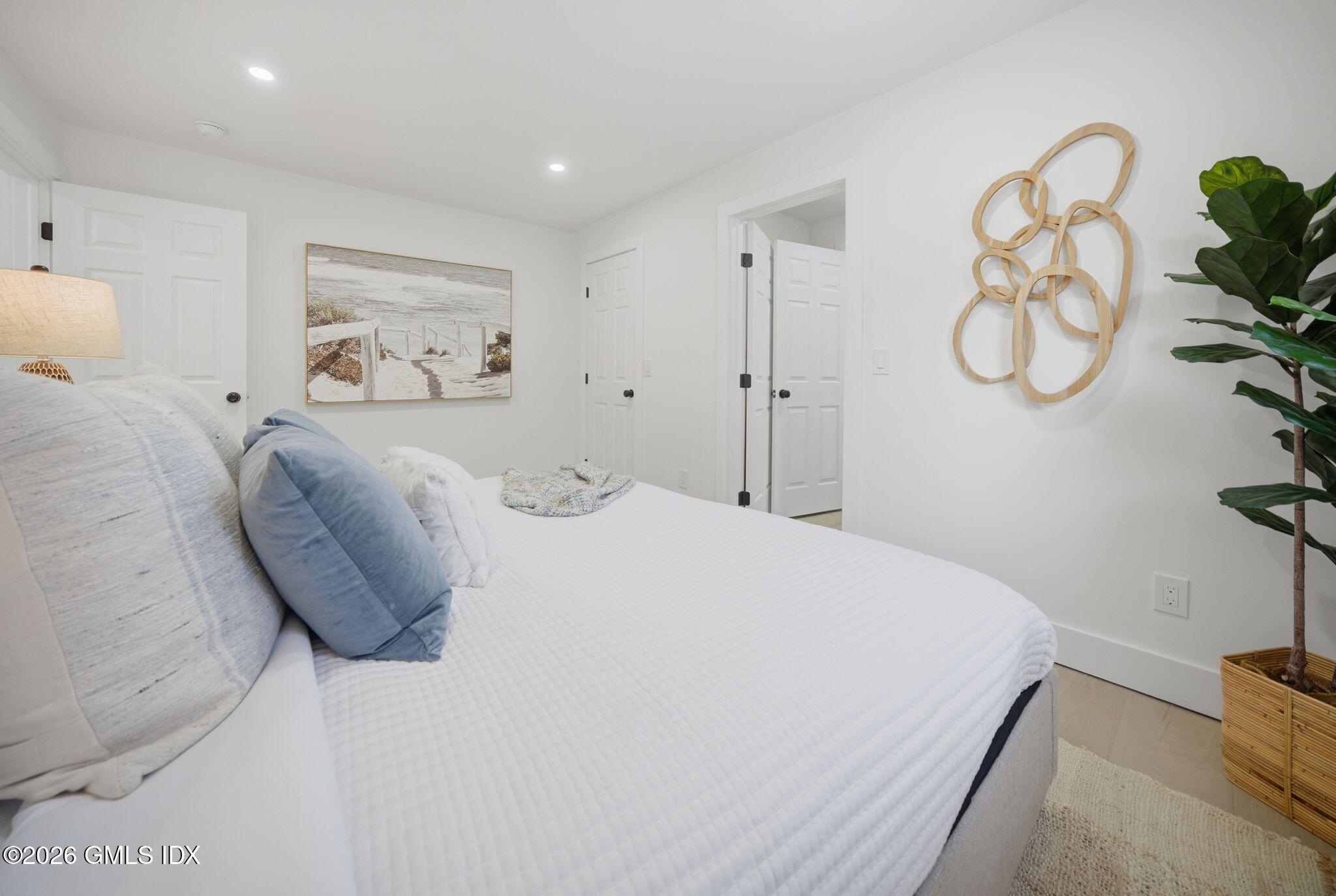 101 Parade Hill Road New Canaan, CT 06840 - Photo 25 of 40 a bedroom with a bed and with a chandelier