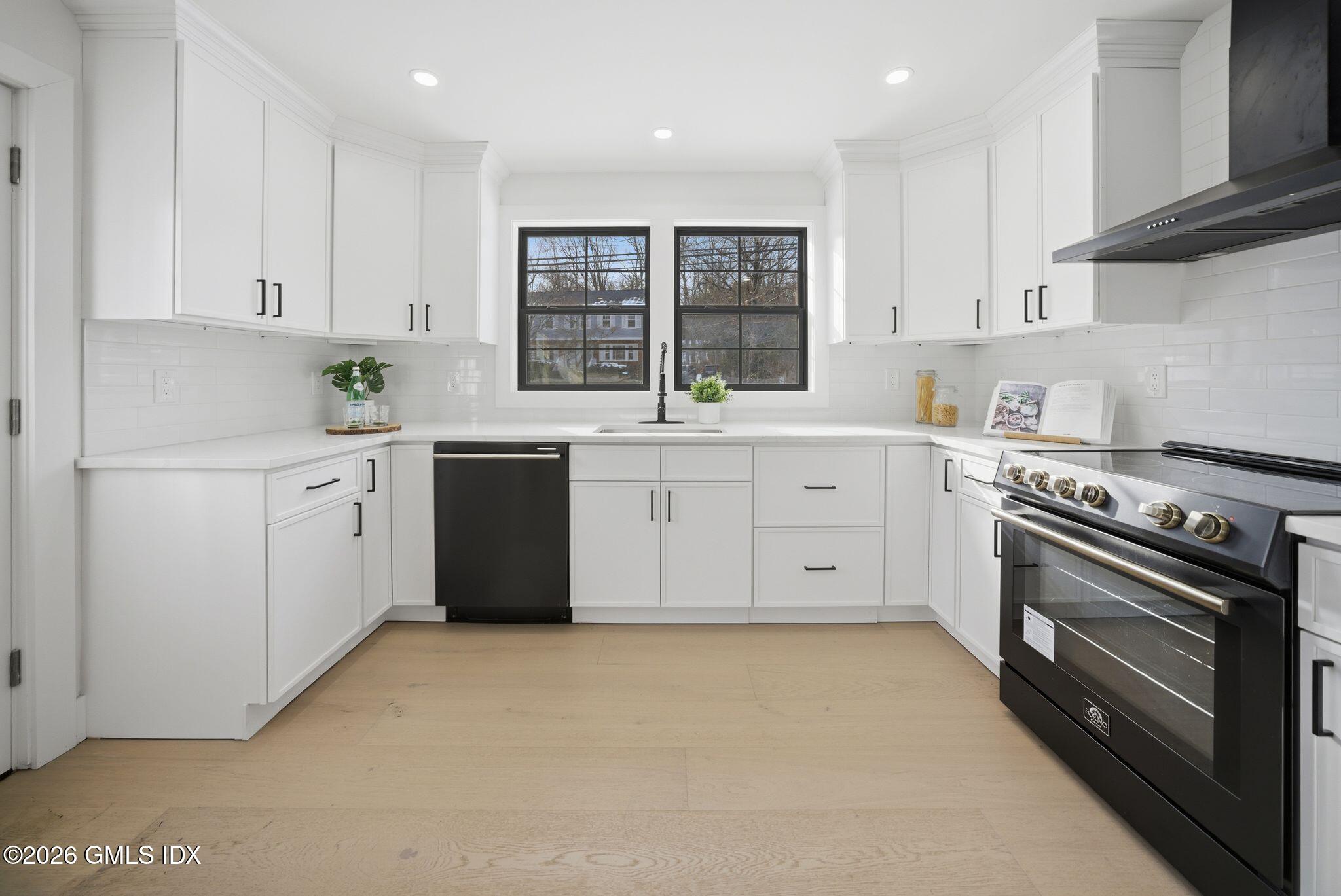 101 Parade Hill Road New Canaan, CT 06840 - Photo 3 of 40 a kitchen with granite countertop white cabinets and stainless steel appliances