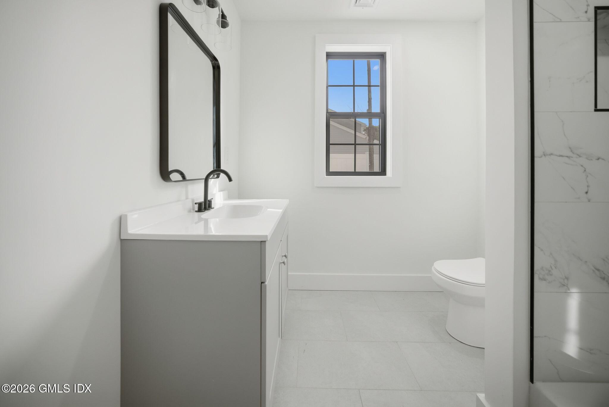 101 Parade Hill Road New Canaan, CT 06840 - Photo 35 of 40 a bathroom with a toilet sink and mirror