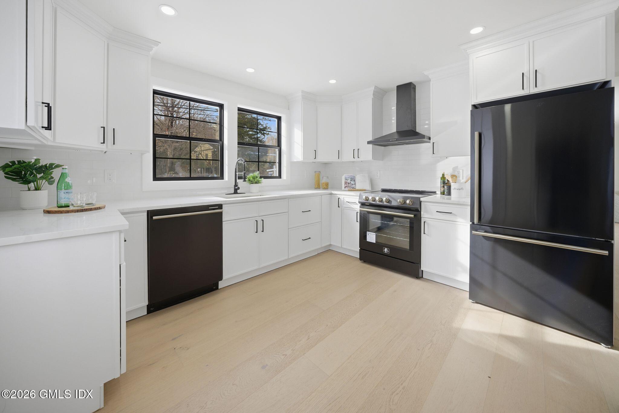 101 Parade Hill Road New Canaan, CT 06840 - Photo 4 of 40 a kitchen with stainless steel appliances granite countertop a stove top oven a refrigerator and a sink