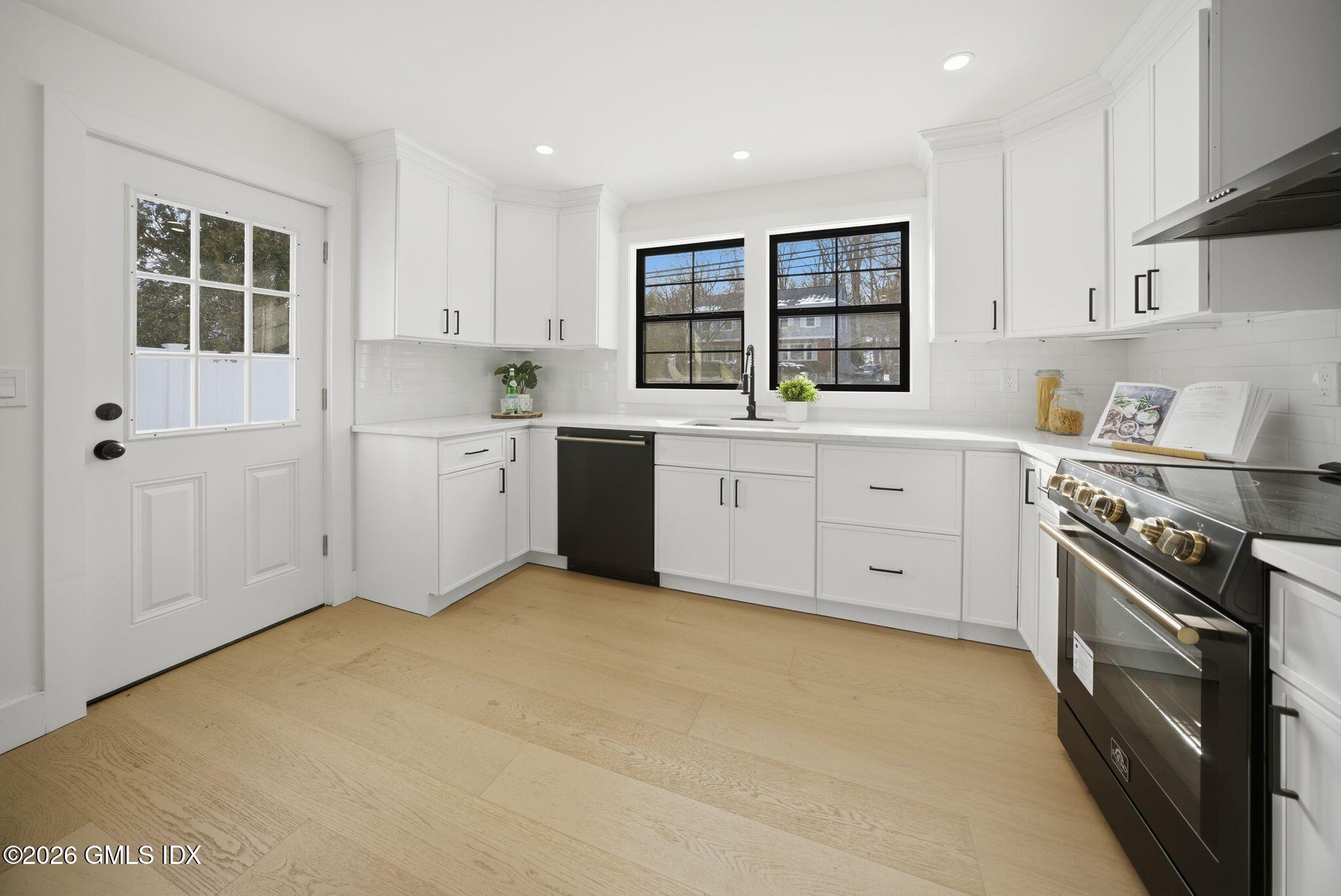 101 Parade Hill Road New Canaan, CT 06840 - Photo 5 of 40 a kitchen with granite countertop a stove sink and cabinets