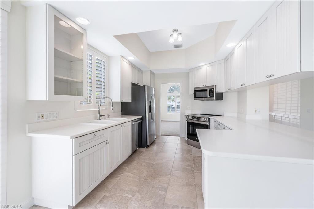 8511 Alessandria Court Naples, FL 34114 - Photo 13 of 45 a large kitchen with a sink dishwasher stove and refrigerator