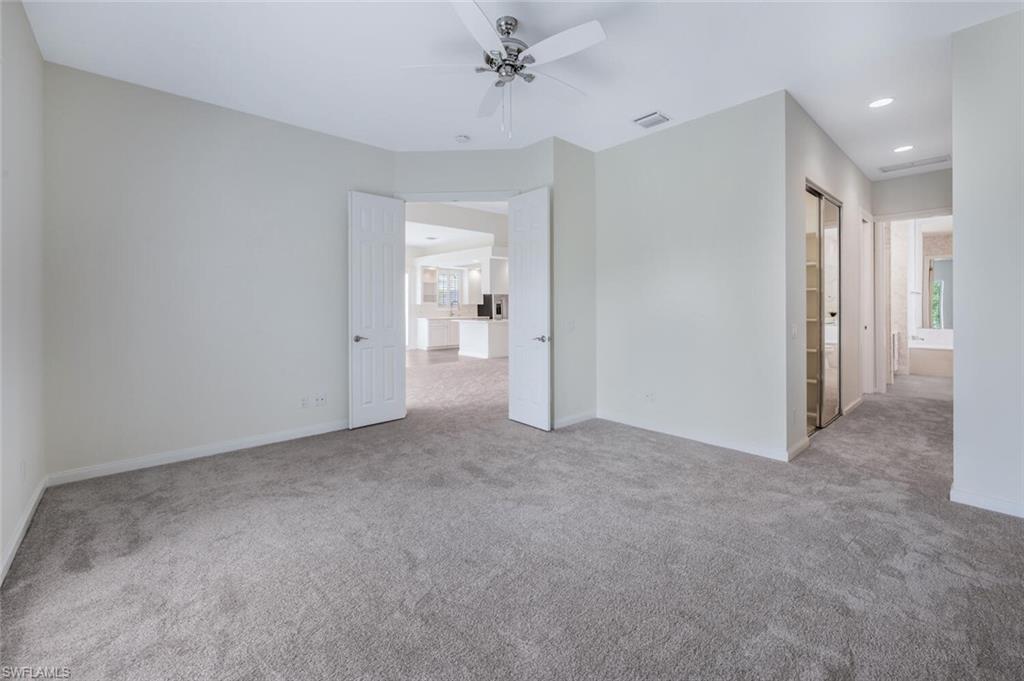 8511 Alessandria Court Naples, FL 34114 - Photo 19 of 45 an empty room with a ceiling fan and entryway