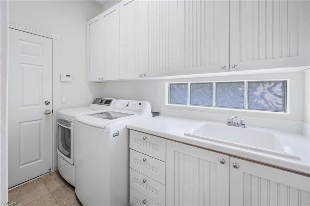 8511 Alessandria Court Naples, FL 34114 - Photo 29 of 45 a utility room with dryer and washer
