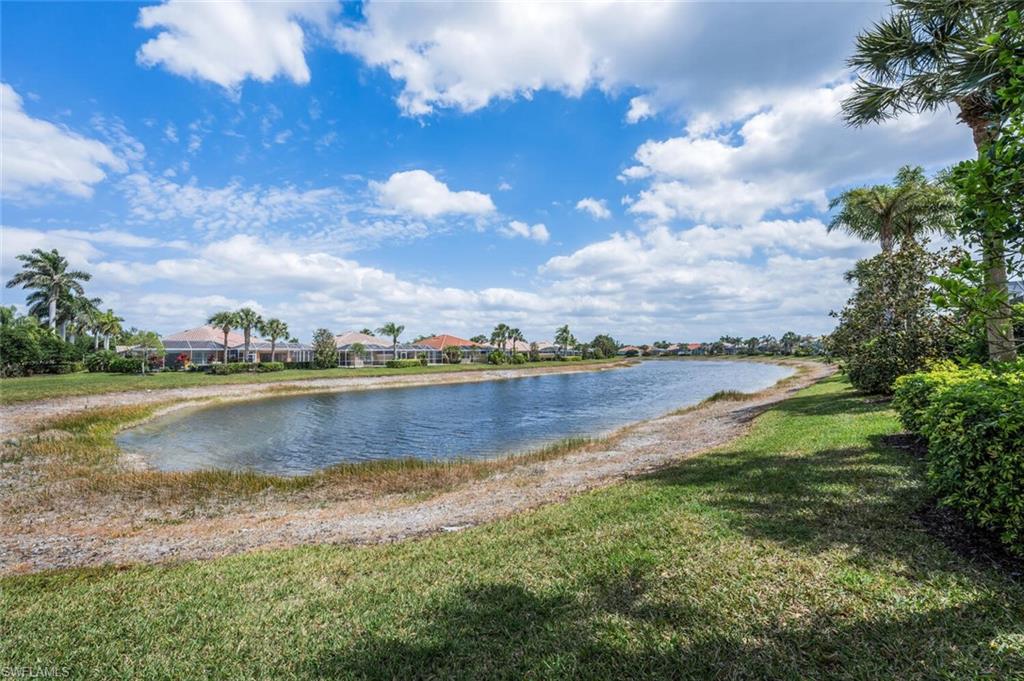 8511 Alessandria Court Naples, FL 34114 - Photo 33 of 45 a view of a lake with houses in the back