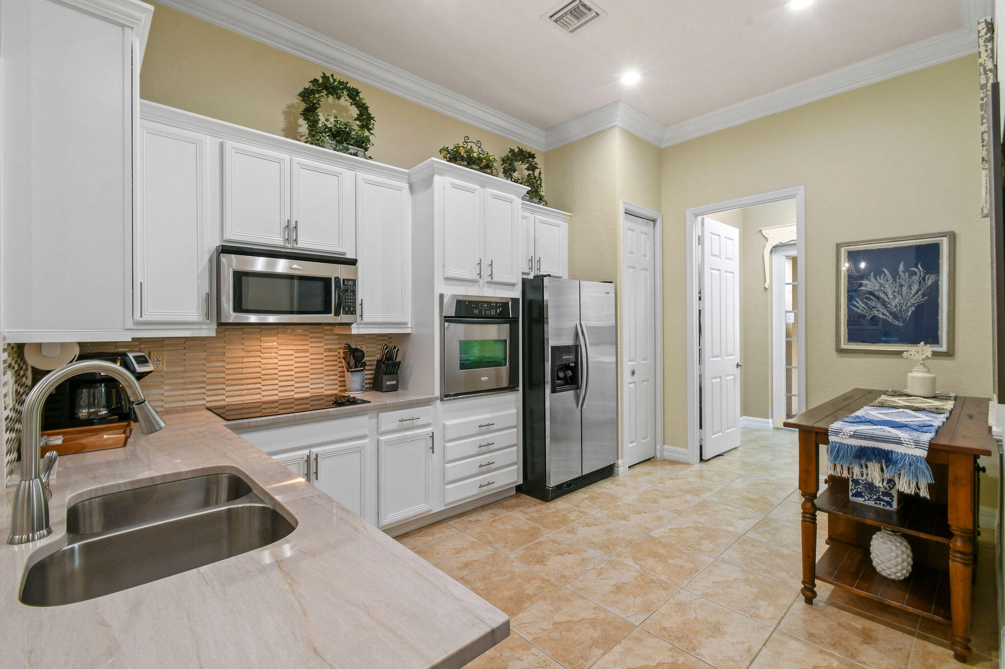 167 Arklow Avenue Jupiter, FL 33458 - Photo 12 of 58 a kitchen with granite countertop a sink stainless steel appliances and cabinets
