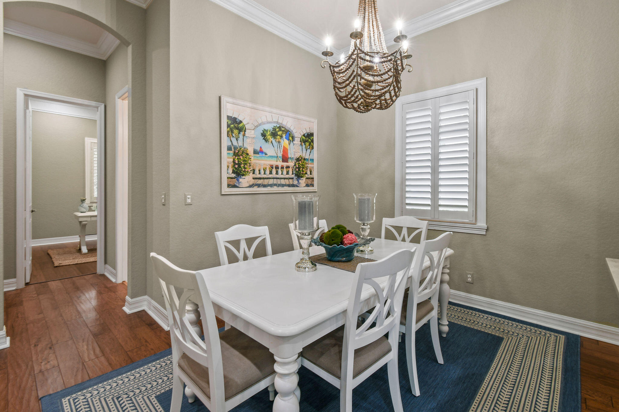 167 Arklow Avenue Jupiter, FL 33458 - Photo 15 of 58 a view of a dining room with furniture wooden floor and a chandelier