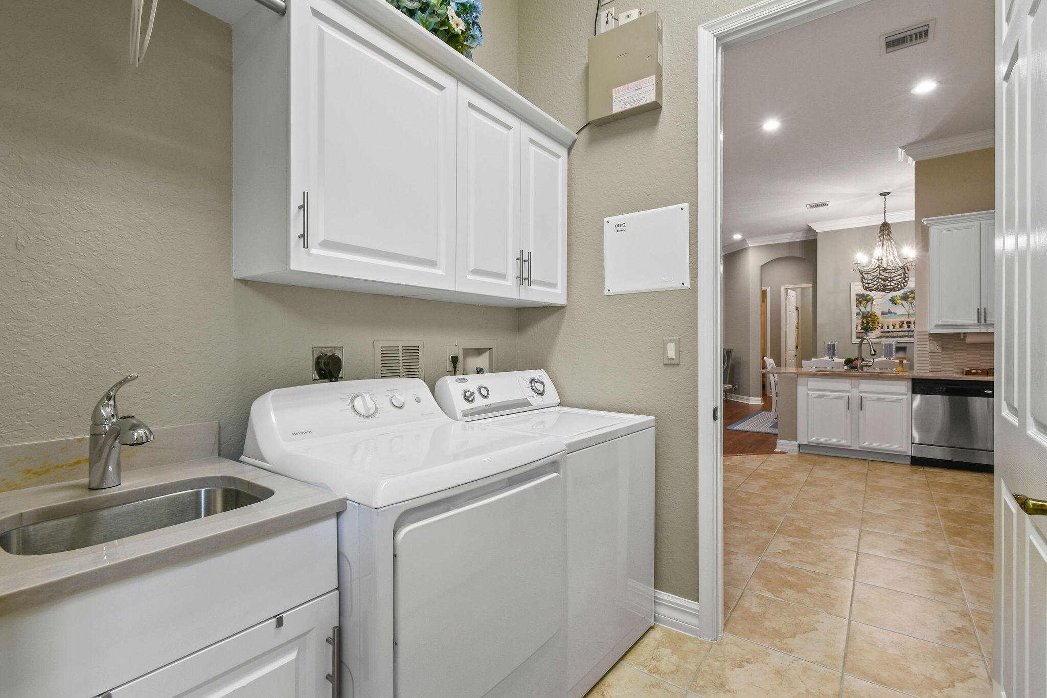 167 Arklow Avenue Jupiter, FL 33458 - Photo 36 of 58 a view of a kitchen with refrigerator and sink