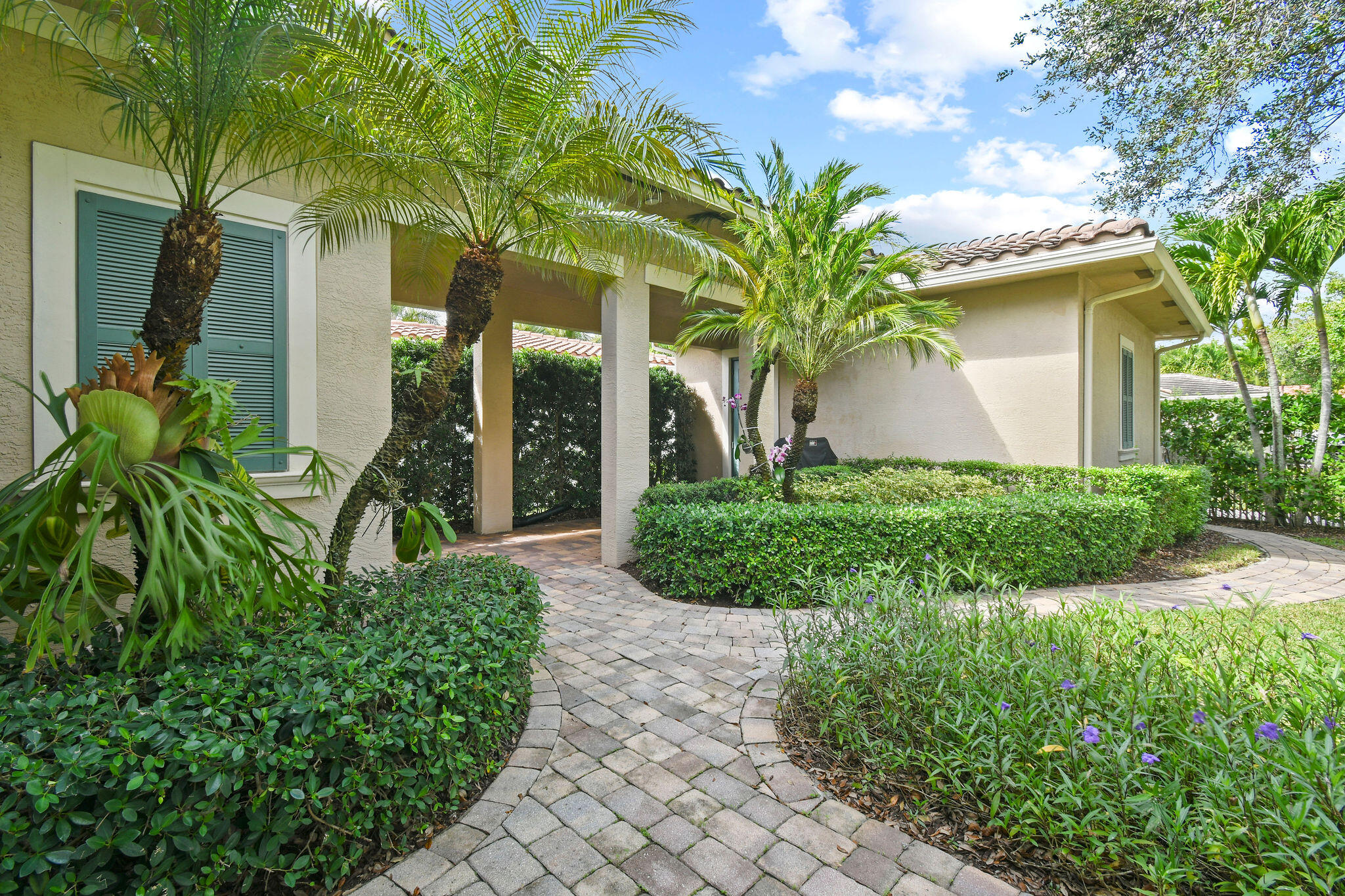 167 Arklow Avenue Jupiter, FL 33458 - Photo 42 of 58 a front view of a house with garden