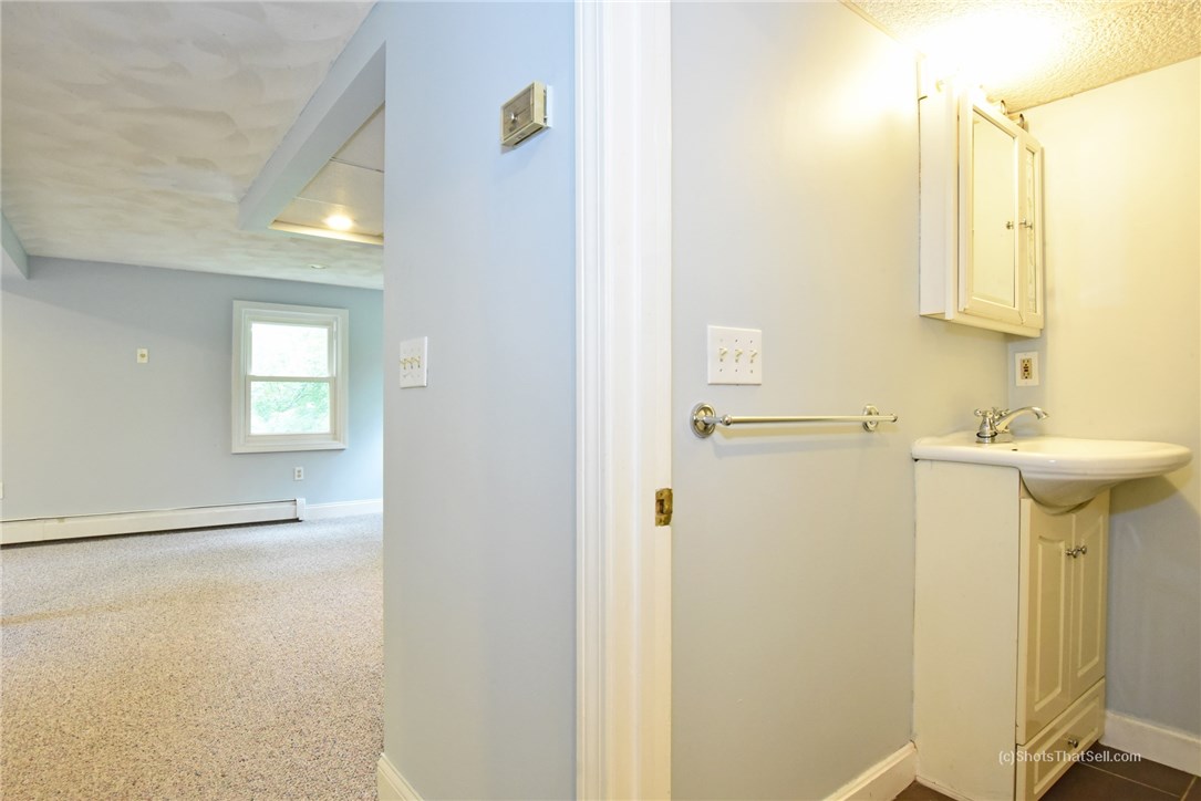 25 Edgewood Road Glocester, RI 02814 - Photo 22 of 33 View from hallway into the lower level bathroom with stand up shower and common/playroom area.