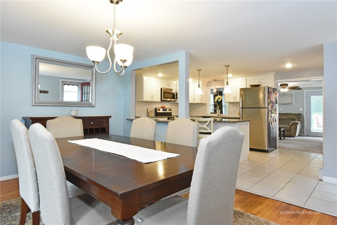 25 Edgewood Road Glocester, RI 02814 - Photo 8 of 33 Nice open layout with view from the dining room into the kitchen and walkout living room with fireplace.