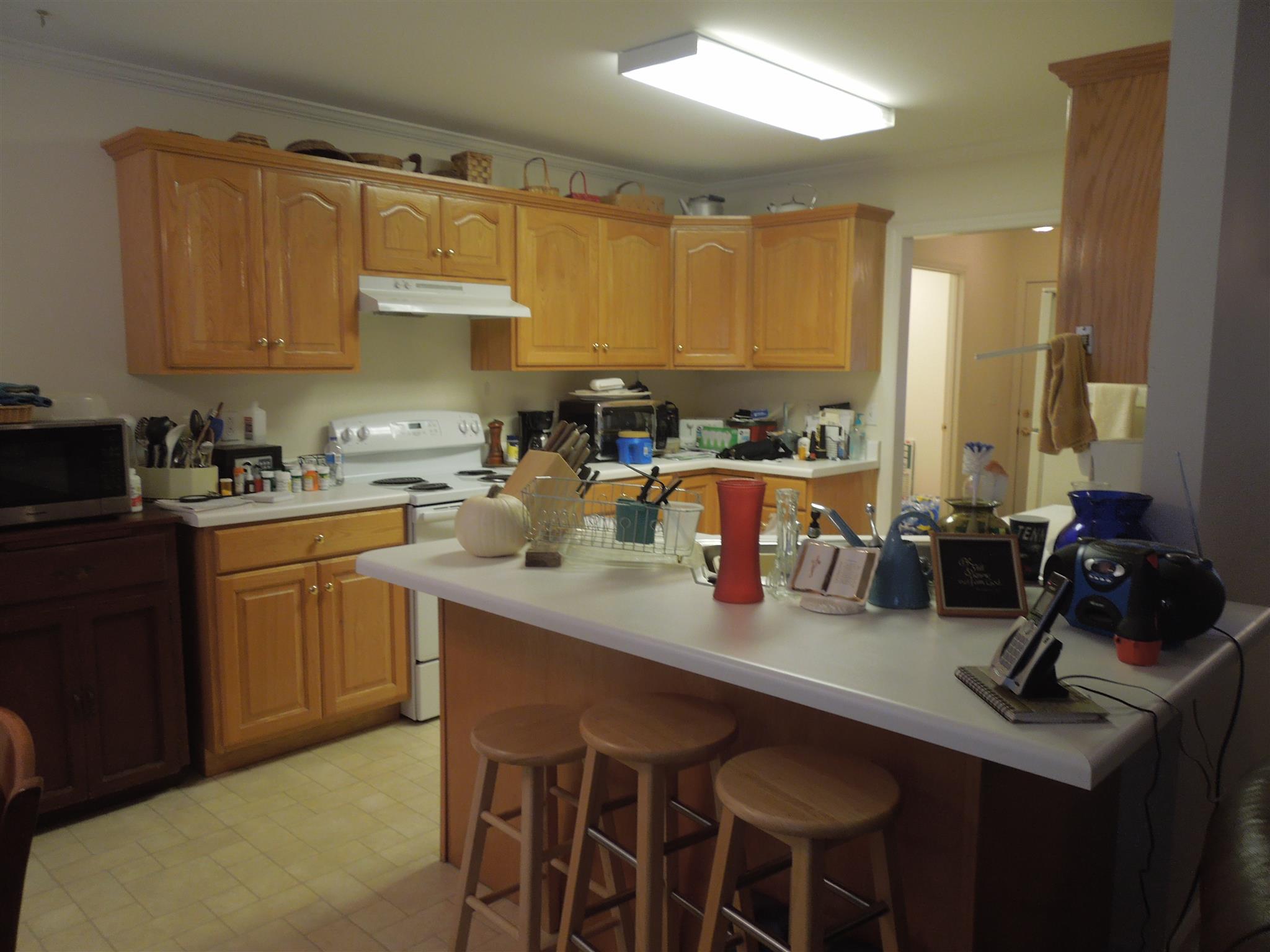 96 Hunt Creek Road Manchester, TN 37355 - Photo 7 of 13 a kitchen with a sink a stove cabinets and chairs