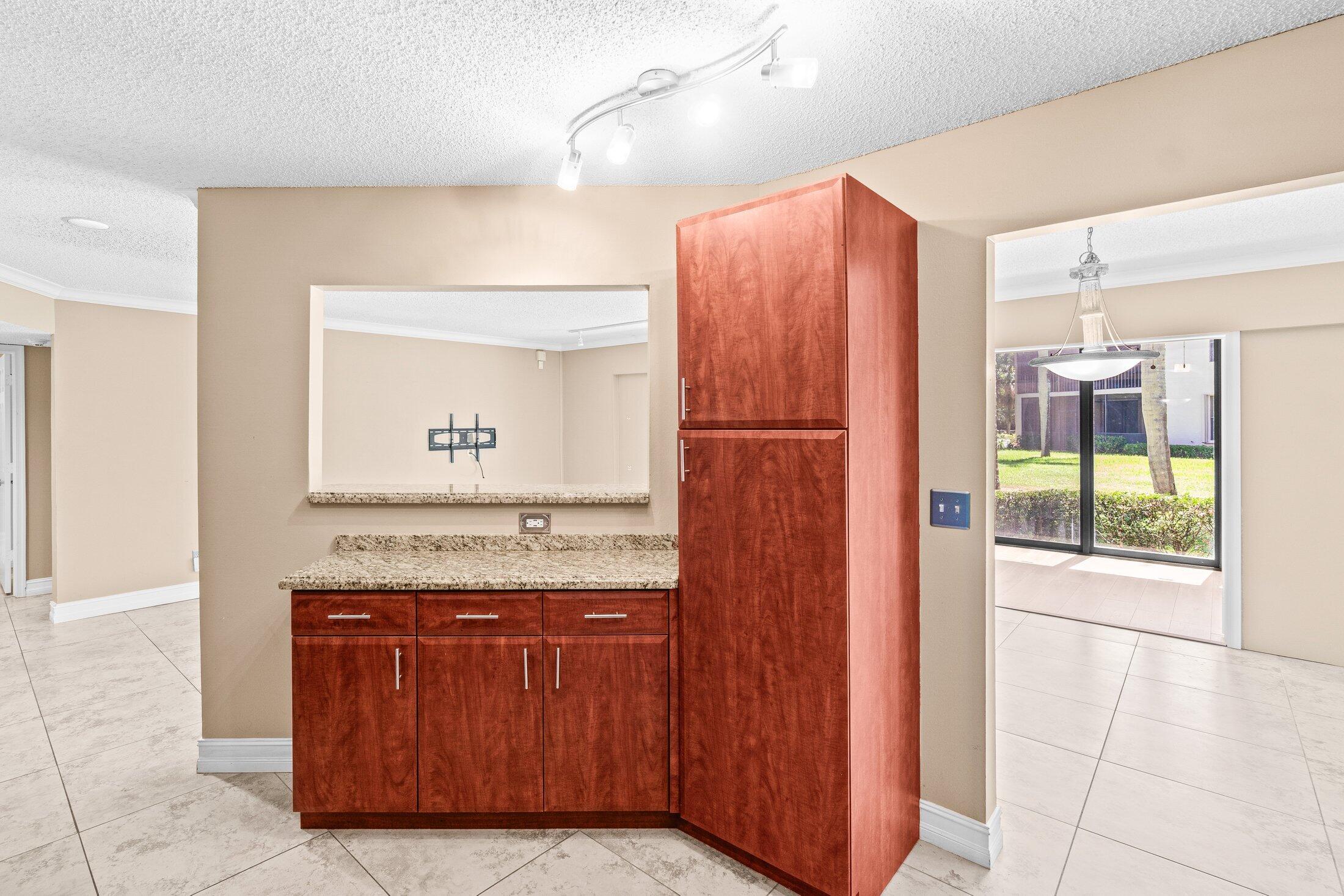 5750 Coach House Circle, Unit C Boca Raton, FL 33486 - Photo 12 of 30 a bathroom with a granite countertop sink and a mirror