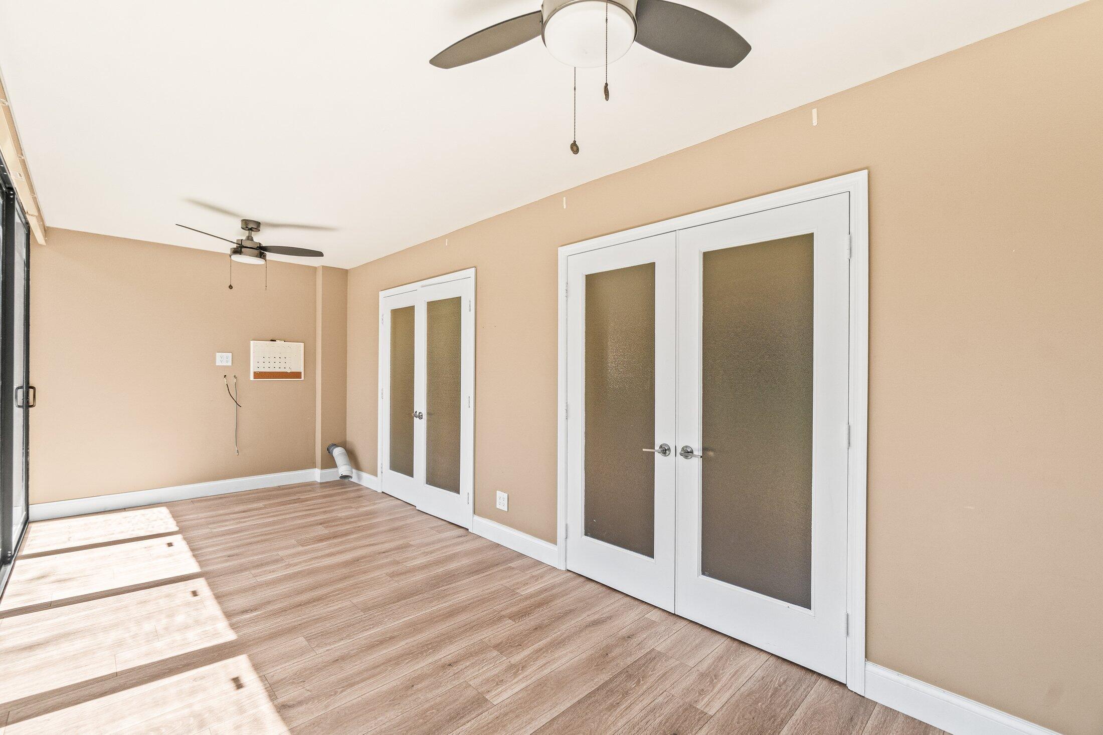 5750 Coach House Circle, Unit C Boca Raton, FL 33486 - Photo 15 of 30 a view of a hallway with wooden floor and a chandelier fan