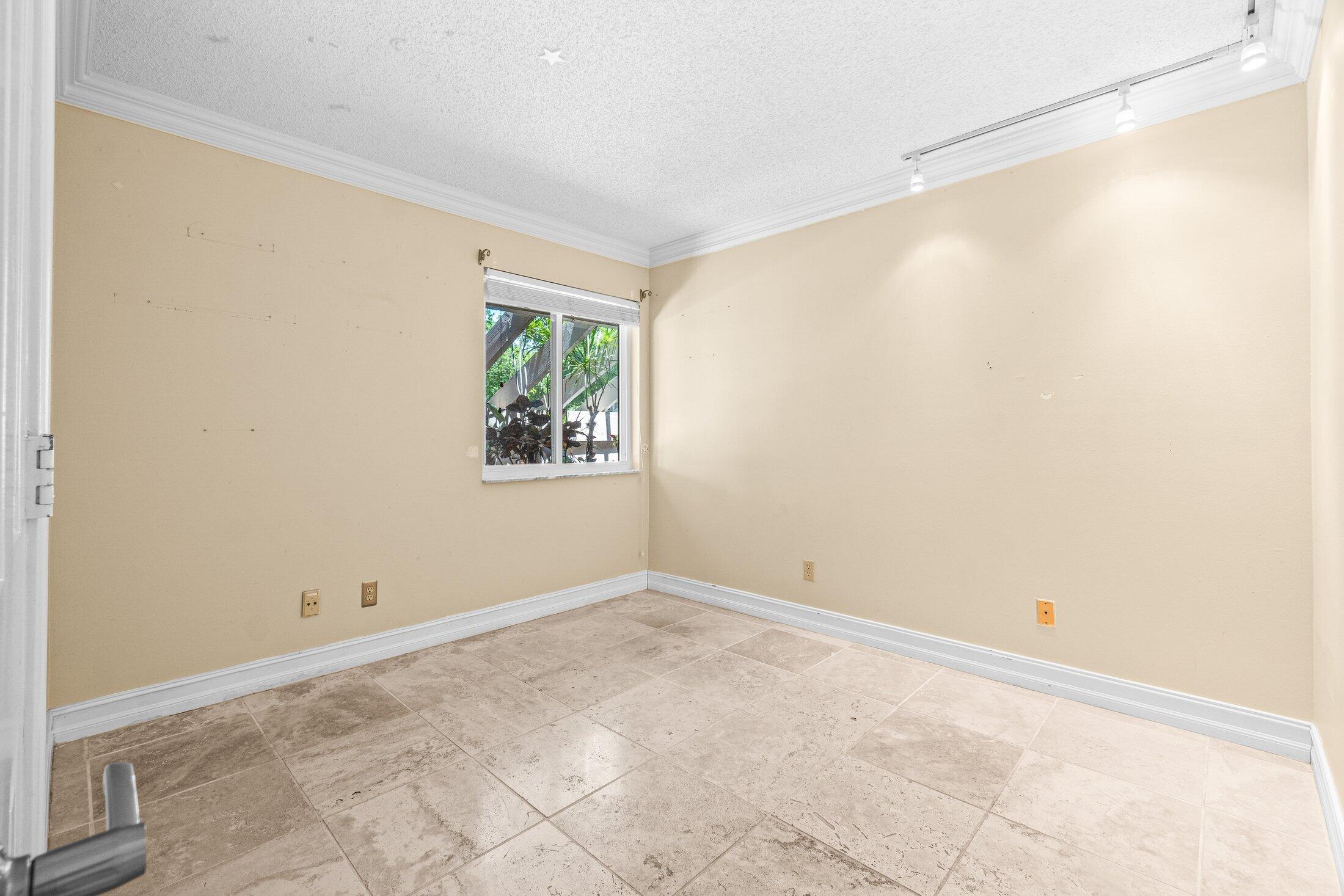 5750 Coach House Circle, Unit C Boca Raton, FL 33486 - Photo 20 of 30 a view of an empty room with a window