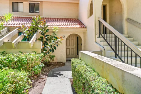 a view of a house with wooden fence
