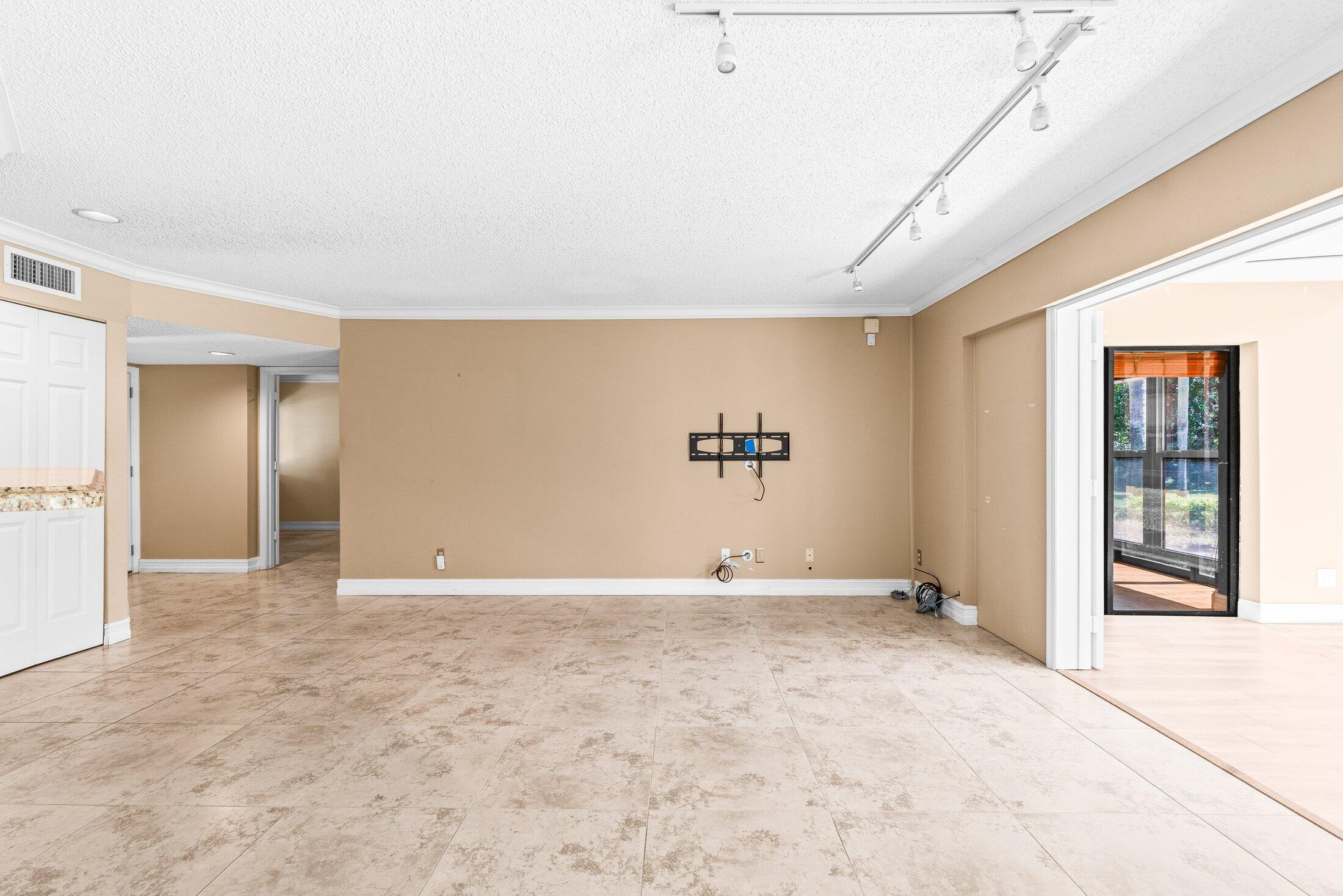 5750 Coach House Circle, Unit C Boca Raton, FL 33486 - Photo 6 of 30 a view of an empty room with window