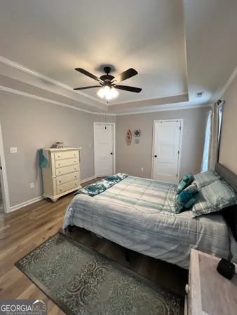 a bedroom with a bed and a chandelier
