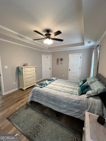 a bedroom with a bed and a chandelier