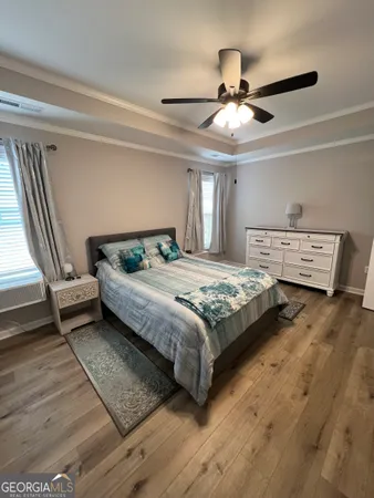 a bedroom with a bed and a ceiling fan