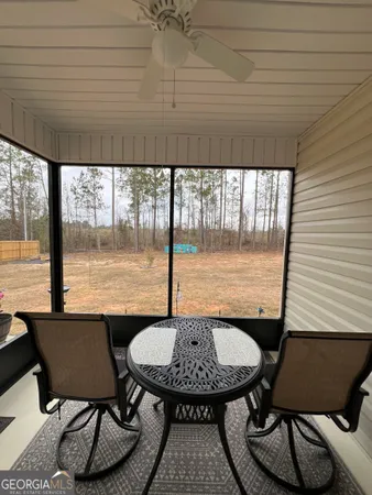 a view of a dining room with furniture and window