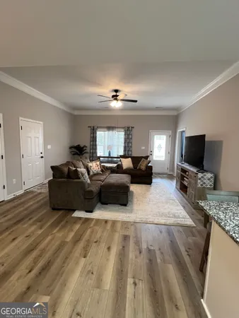 a living room with furniture and a flat screen tv