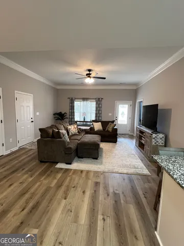 a living room with furniture and a flat screen tv