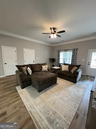 a living room with furniture and a chandelier