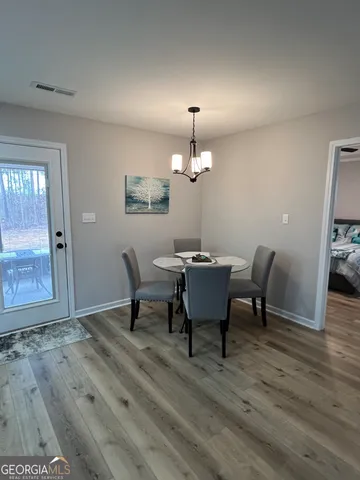 a view of a dining room with furniture and wooden floor