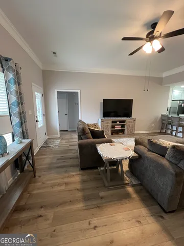 a living room with furniture and a flat screen tv