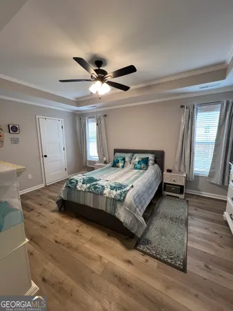 a bedroom with a large bed and a chandelier
