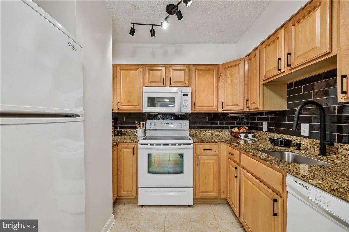 2111 Wisconsin Avenue Northwest, Unit 118 Washington, DC 20007 - Photo 11 of 61 a kitchen with a stove cabinets and a sink