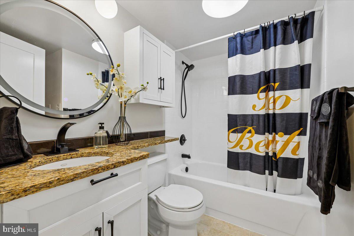 2111 Wisconsin Avenue Northwest, Unit 118 Washington, DC 20007 - Photo 18 of 61 a bathroom with a sink and mirror with toilet