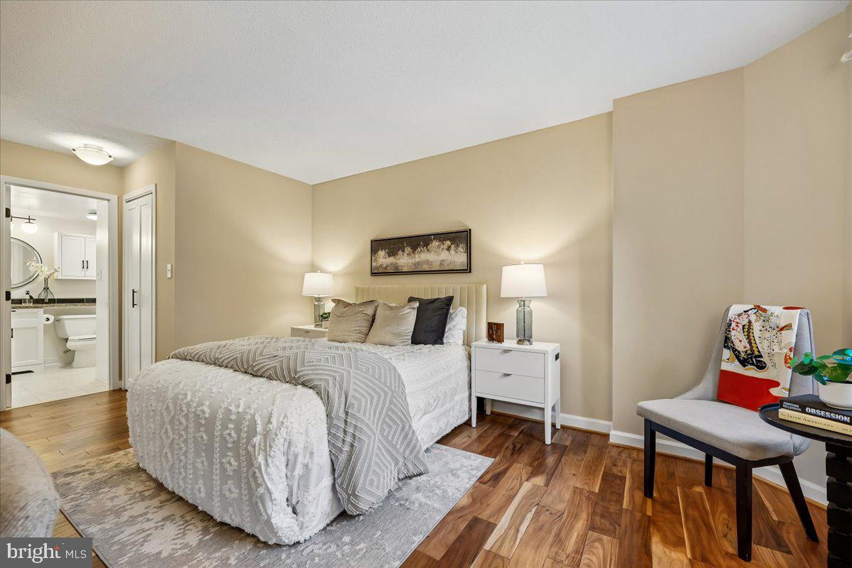 2111 Wisconsin Avenue Northwest, Unit 118 Washington, DC 20007 - Photo 22 of 61 a bedroom with a bed and wooden floor