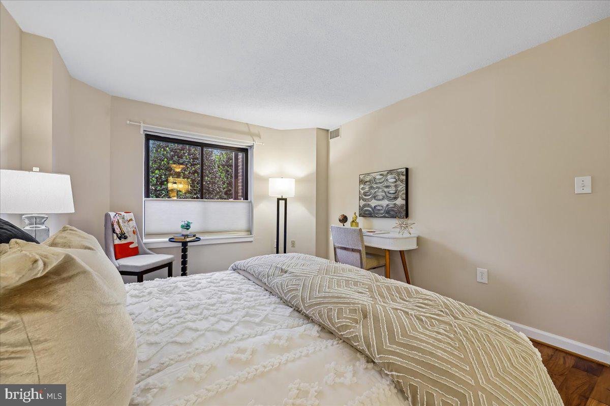 2111 Wisconsin Avenue Northwest, Unit 118 Washington, DC 20007 - Photo 25 of 61 a bedroom with a bed and wooden floor