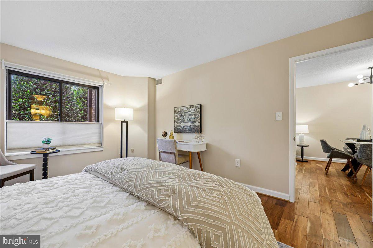 2111 Wisconsin Avenue Northwest, Unit 118 Washington, DC 20007 - Photo 26 of 61 a bedroom with a bed and wooden floor