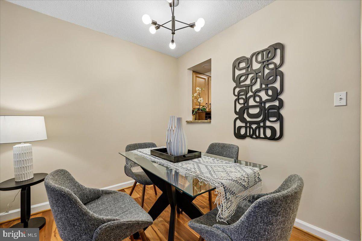 2111 Wisconsin Avenue Northwest, Unit 118 Washington, DC 20007 - Photo 28 of 61 a dining room with furniture and wooden floor