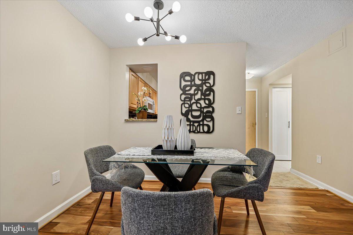 2111 Wisconsin Avenue Northwest, Unit 118 Washington, DC 20007 - Photo 29 of 61 a view of a dining room with furniture and wooden floor
