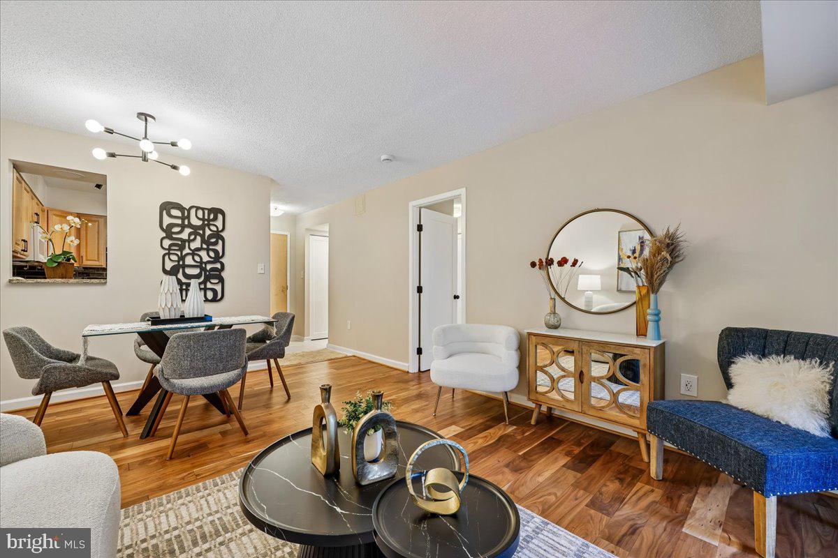 2111 Wisconsin Avenue Northwest, Unit 118 Washington, DC 20007 - Photo 30 of 61 a living room with furniture a clock on wall and a window