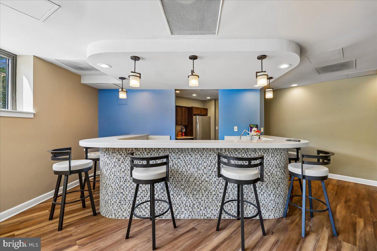 2111 Wisconsin Avenue Northwest, Unit 118 Washington, DC 20007 - Photo 45 of 61 a view of a kitchen with granite countertop kitchen island stainless steel appliances a dining table and chairs